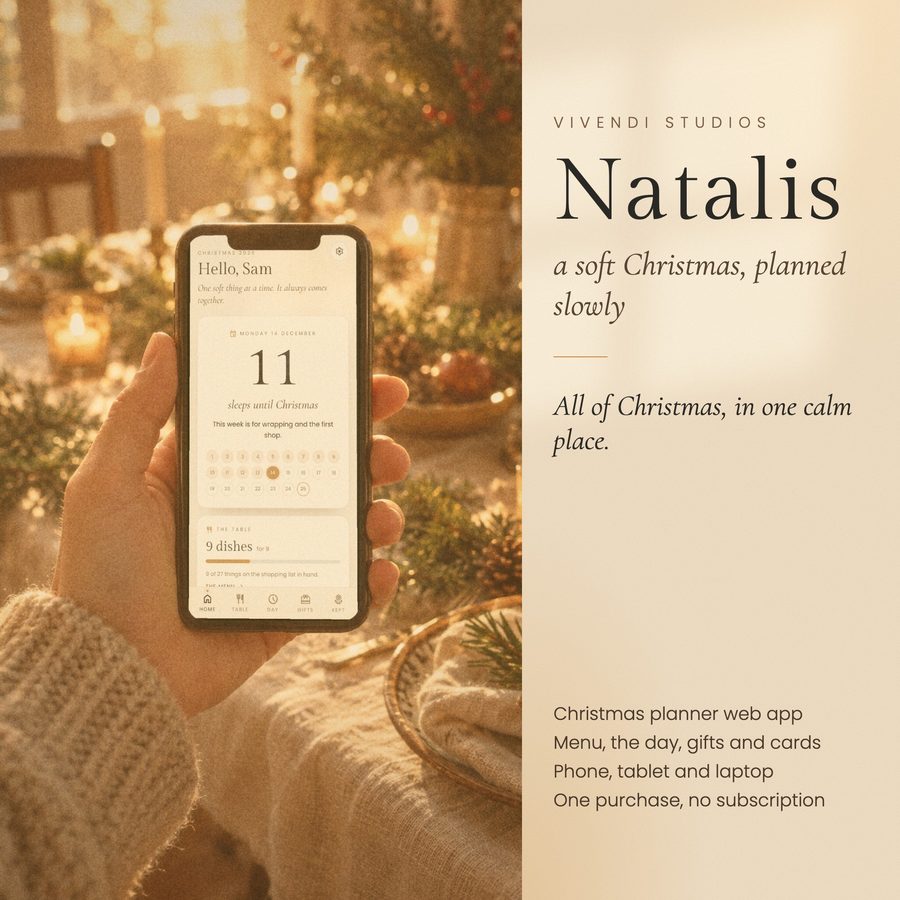 Natalis on a phone held over a candlelit Christmas table